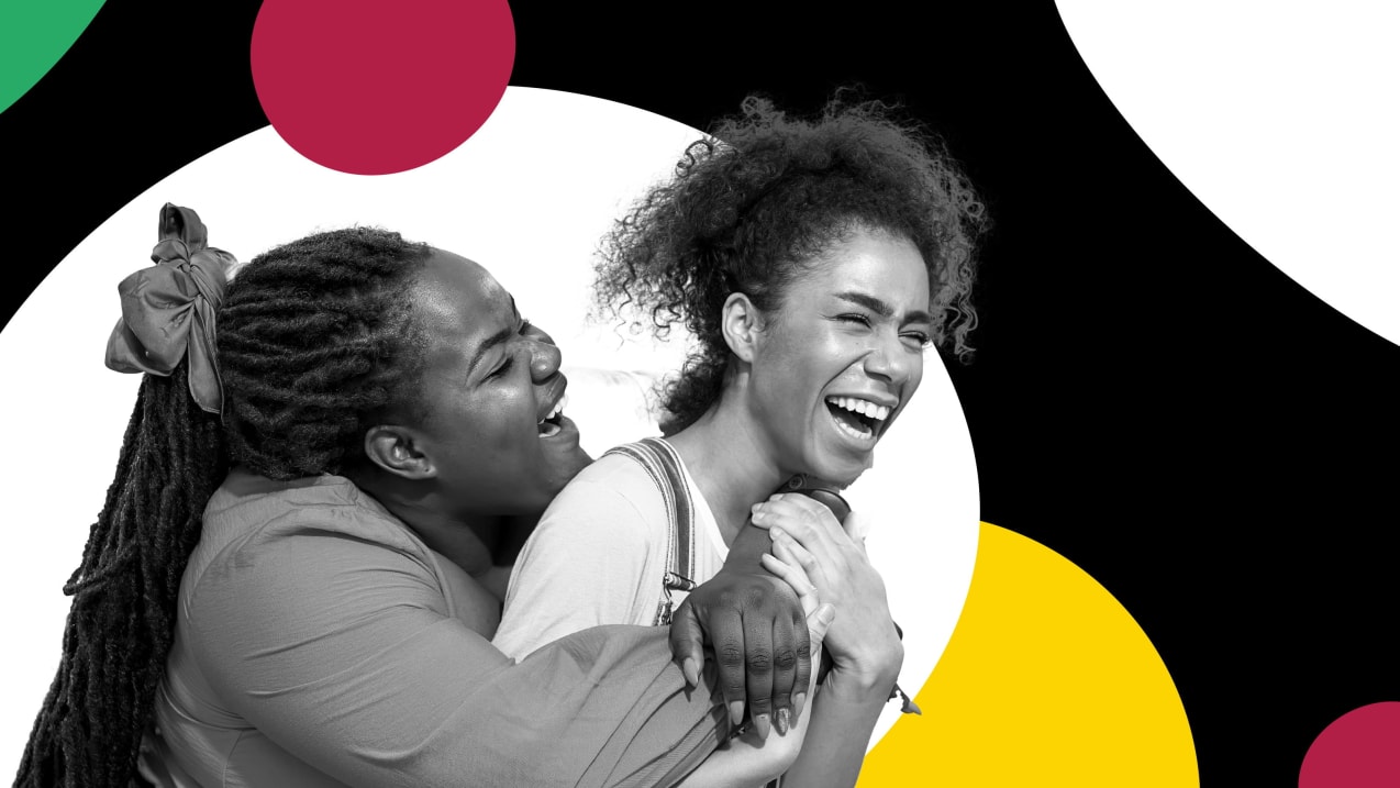 Two ladies laughing, with The Well branding behind them