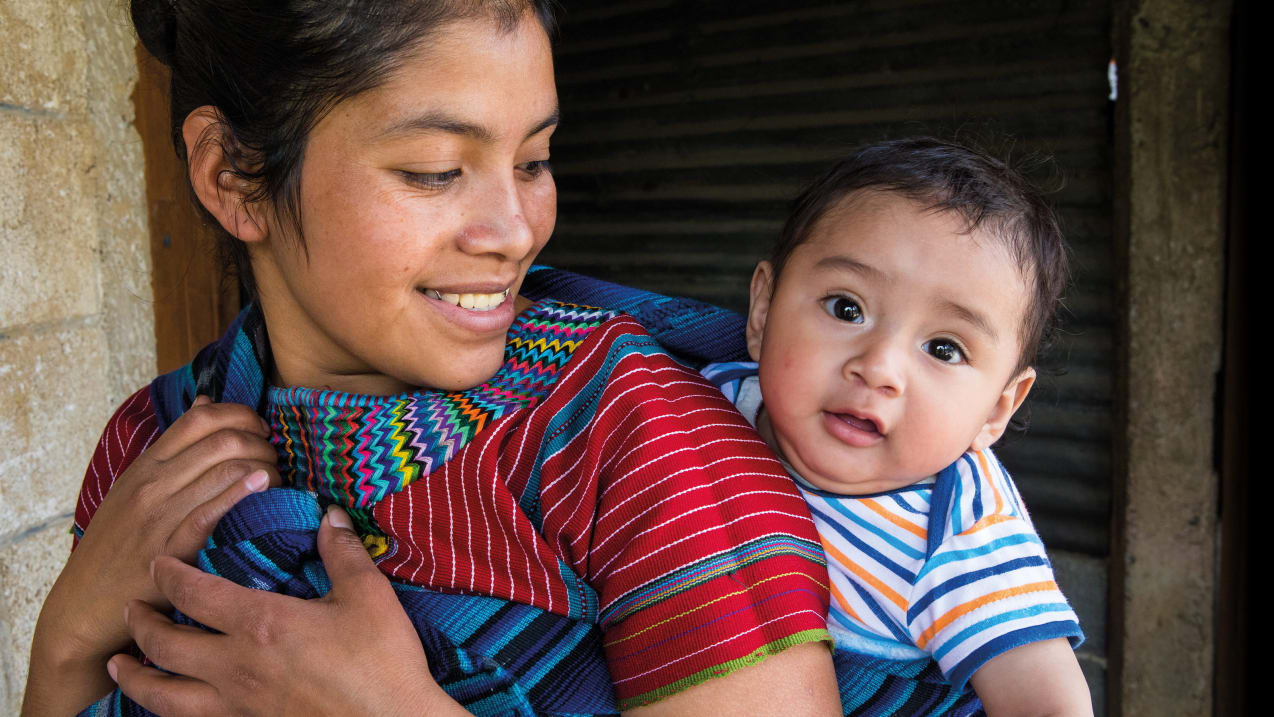 Josefina, carrying her baby son on her back in San Juan La Laguna, Guatemala. Credit: Caroline Trutman/Tearfund