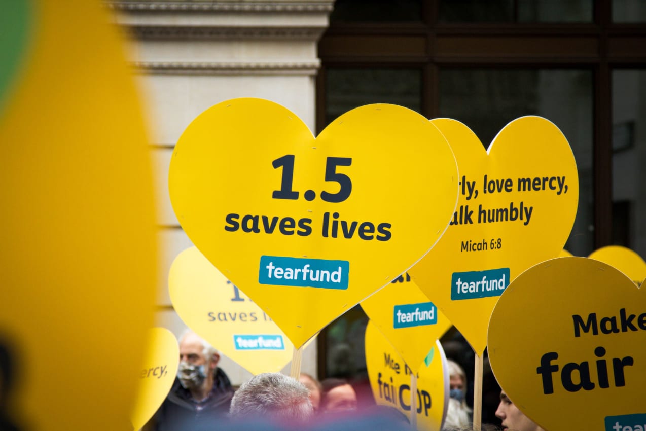 Protest sign at COP26 in Glasgow saying '1.5 saves lives', November 2021