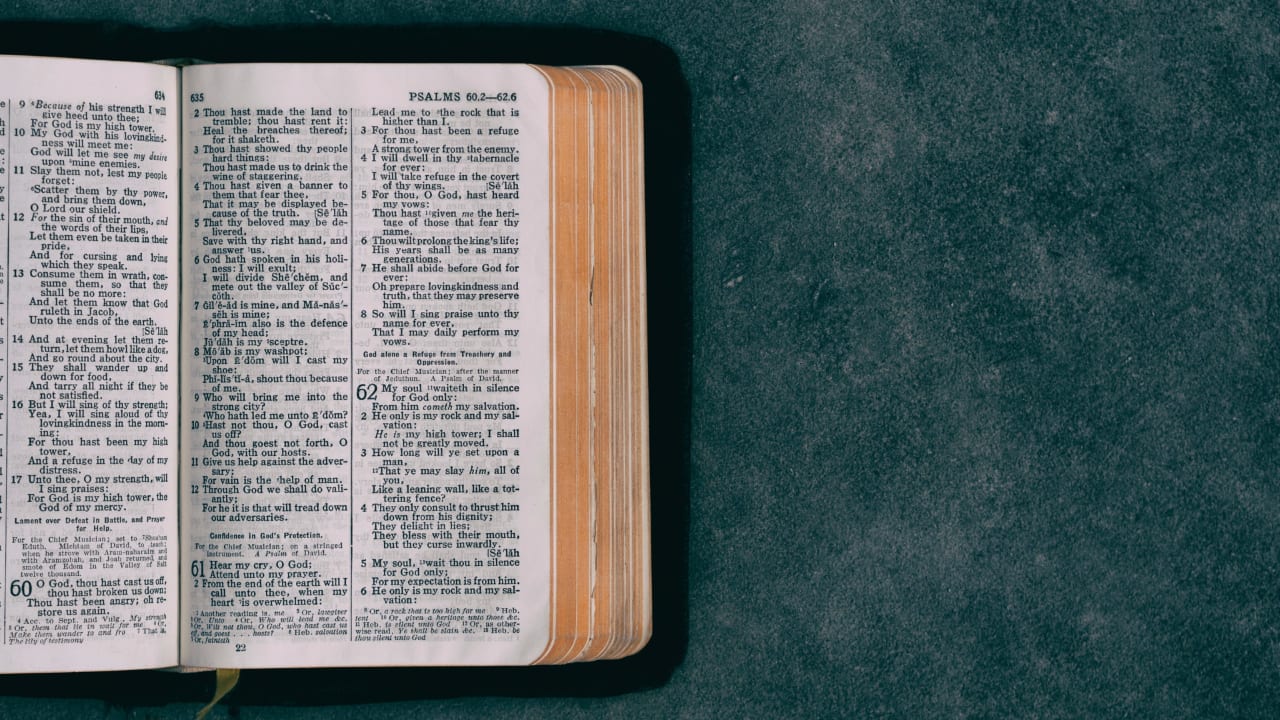 Image of a bible open on a grey surface