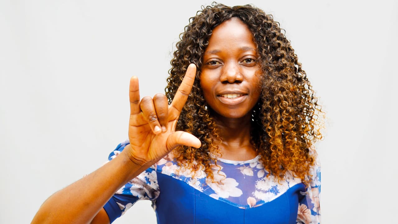 A young woman in Zimbabwe demonstrates Zimbabwean Sign Language