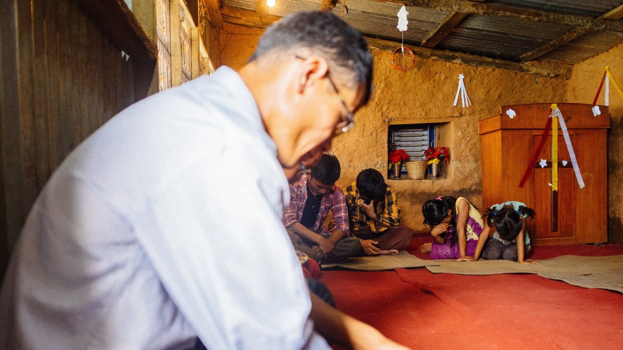 A group praying in Nepal. Photo: Andrew Philip/Tearfund