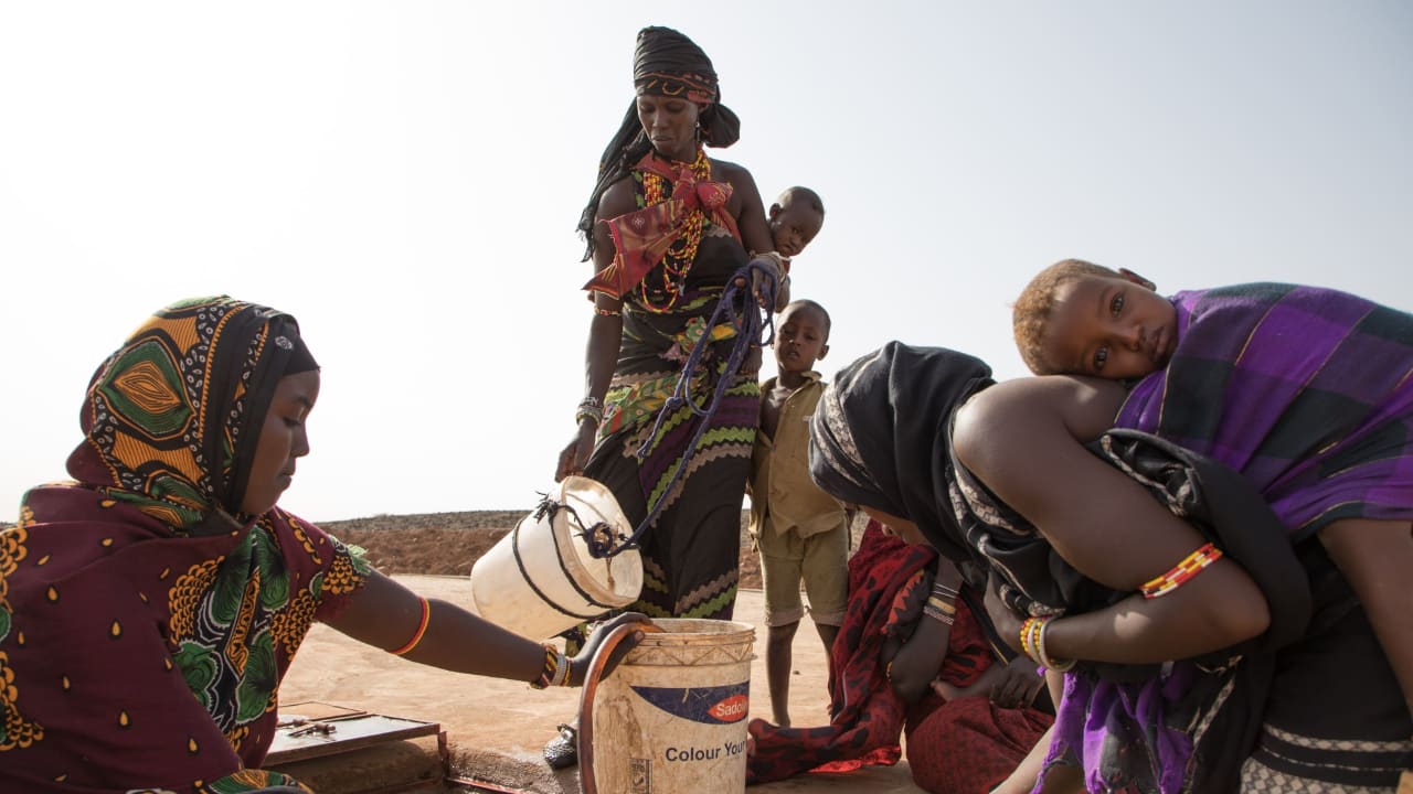 Women and children draw water from the community well. 