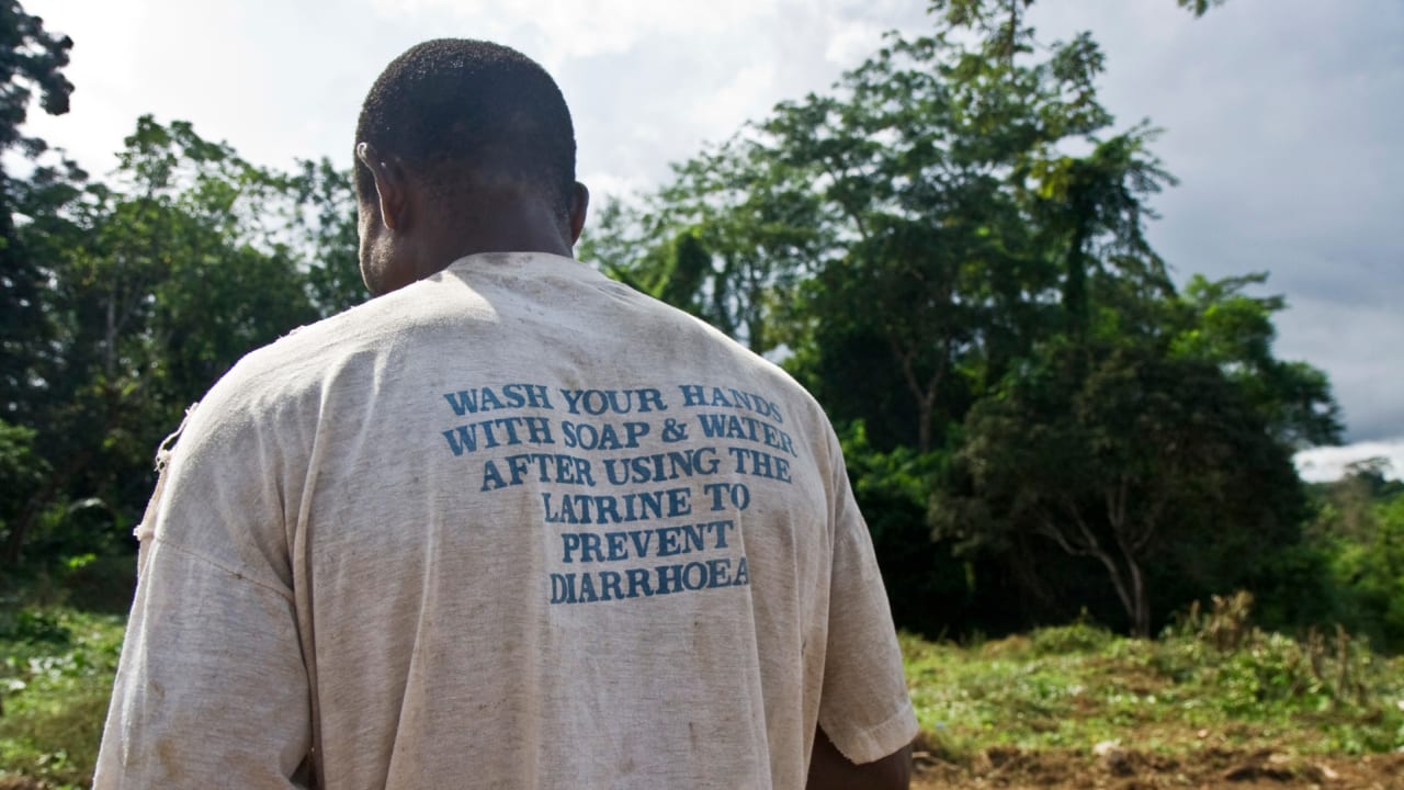 Man in Liberia wears a t-shirt encouraging good sanitation.