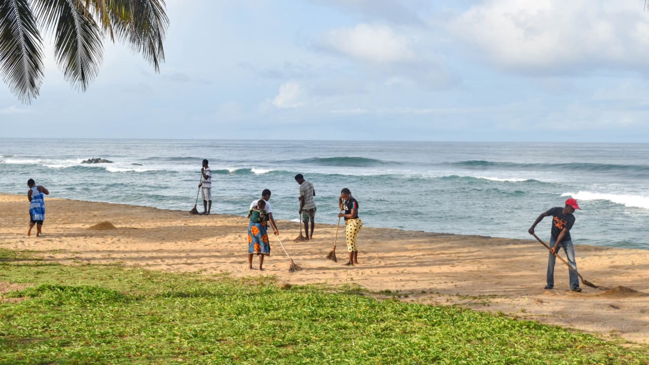 Partnering with local communities, the Liberian government employs individuals to sweep the beach each morning to keep it clean.