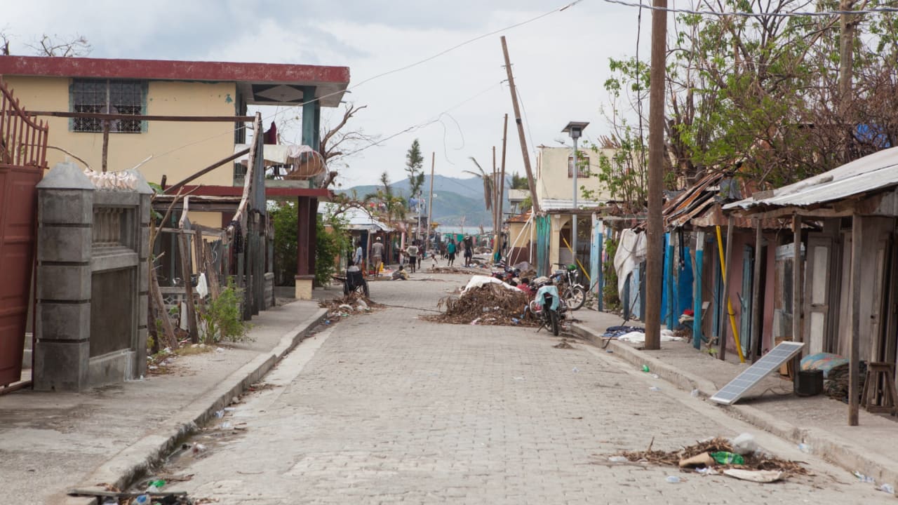 Damaged buildings and piles of debris in the aftermath of Hurricane Matthew.