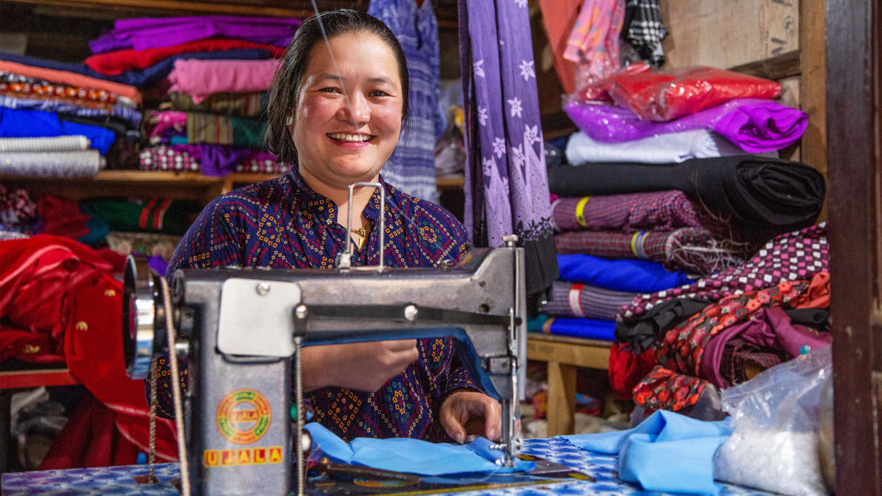 Off-grid renewable electricity enables a woman in Nepal to continue working in her tailoring business after dark.