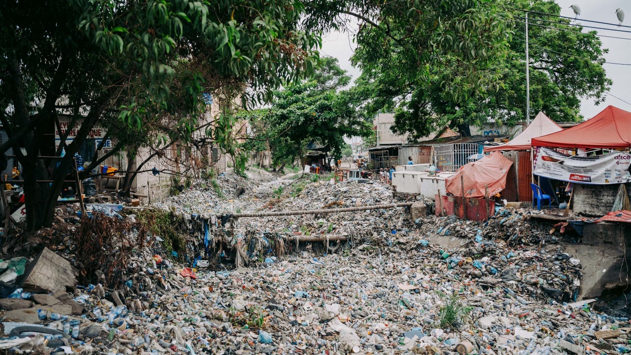 Street scenes in Kinshasa, showing the impact of plastic waste in the waterways of the city. 