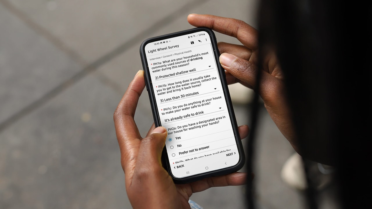 Light Wheel survey on a mobile phone held by an african person