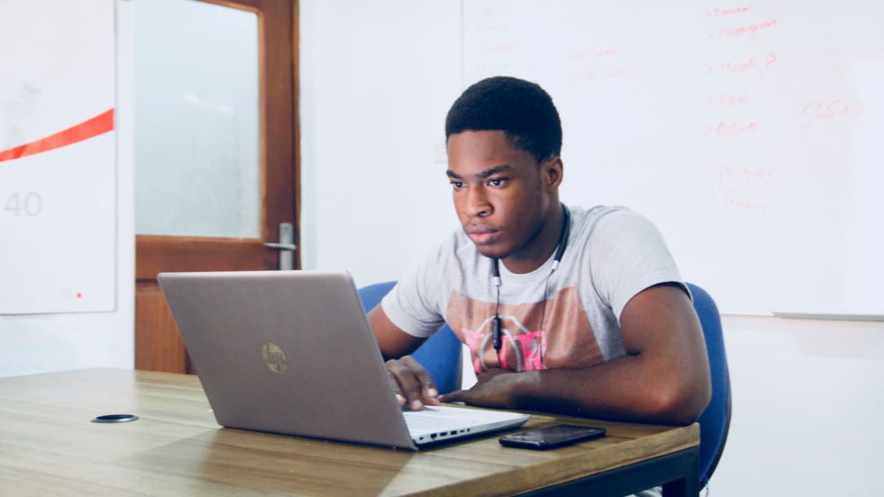 A man in Nigeria does research on his computer