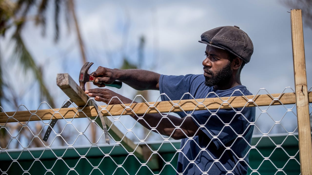 Man repairs a building in his village of Siuiri, Vanuatu. He received training in DRR which helped his community prepare for Cyclone Pam