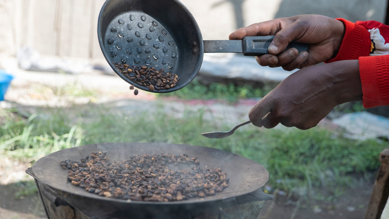 Coffee beans being roasted outside