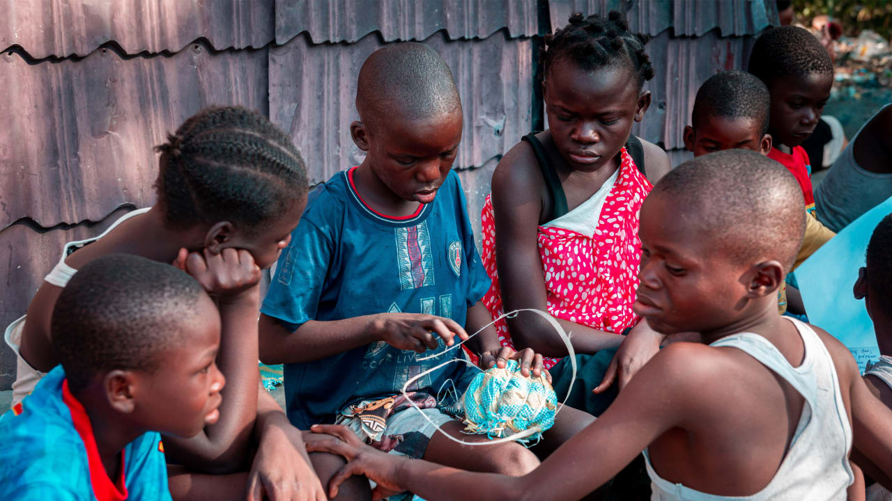 Photo of group of children constructing a football from recycled materials