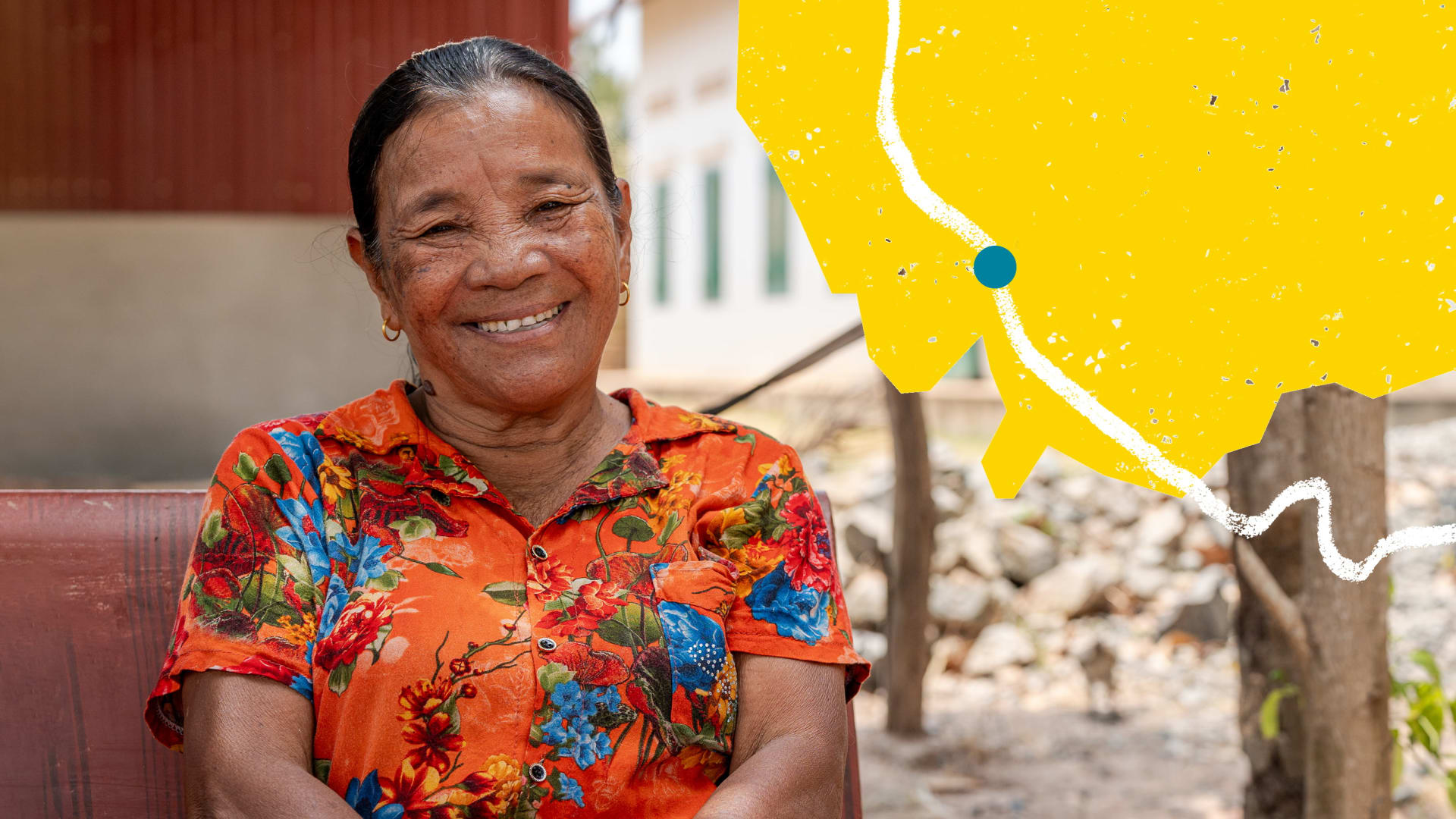 A photo of a woman smiling, wearing a brightly coloured orange and floral top. To the side there is an illustration  