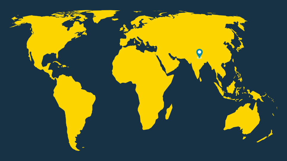 Yellow world map on dark blue background with a location pin on Nepal.