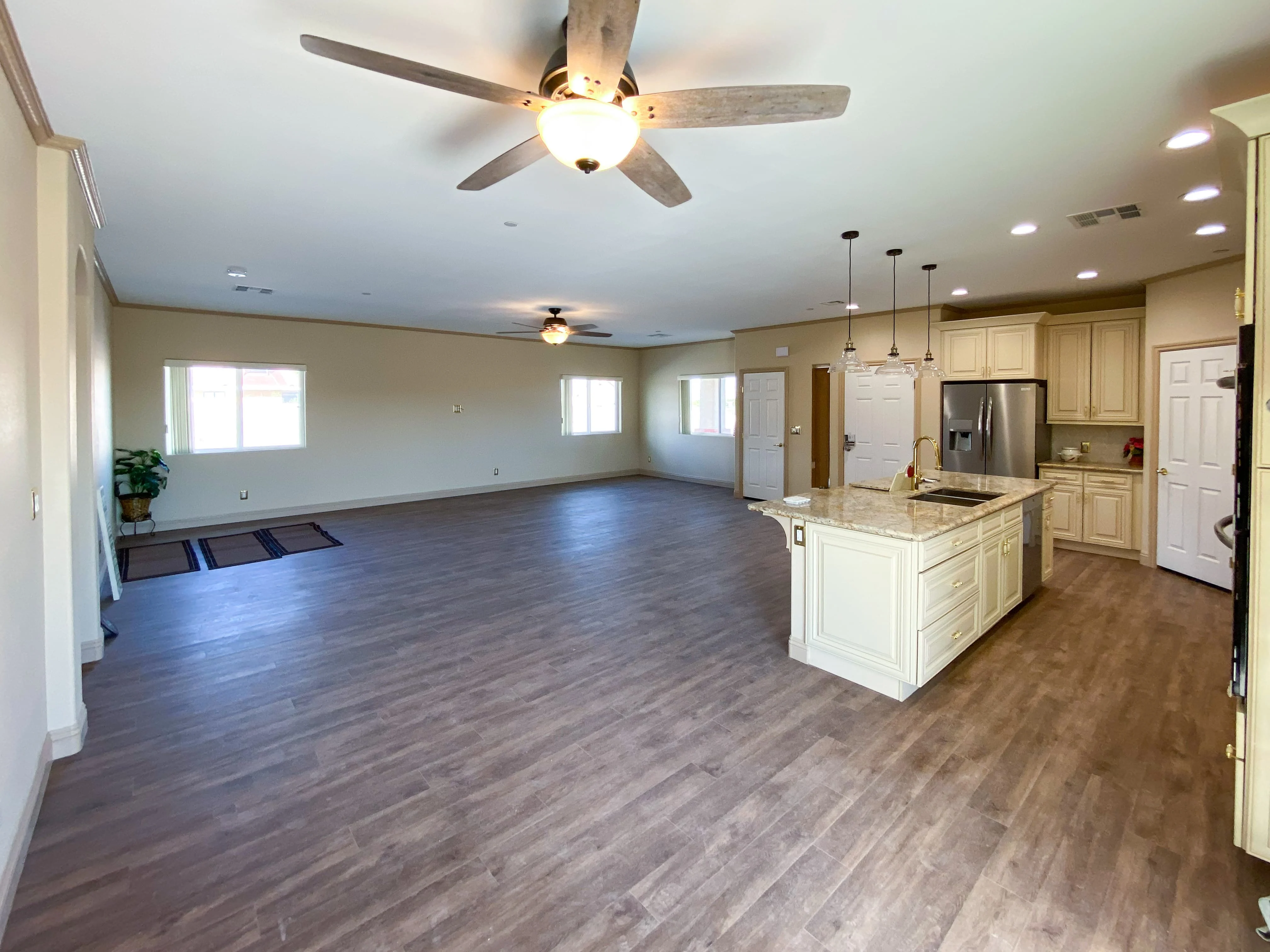 Open-concept living space combining dining and kitchen areas, flooded with natural light - Custom Home built by James Development Corp. Las Vegas, NV.