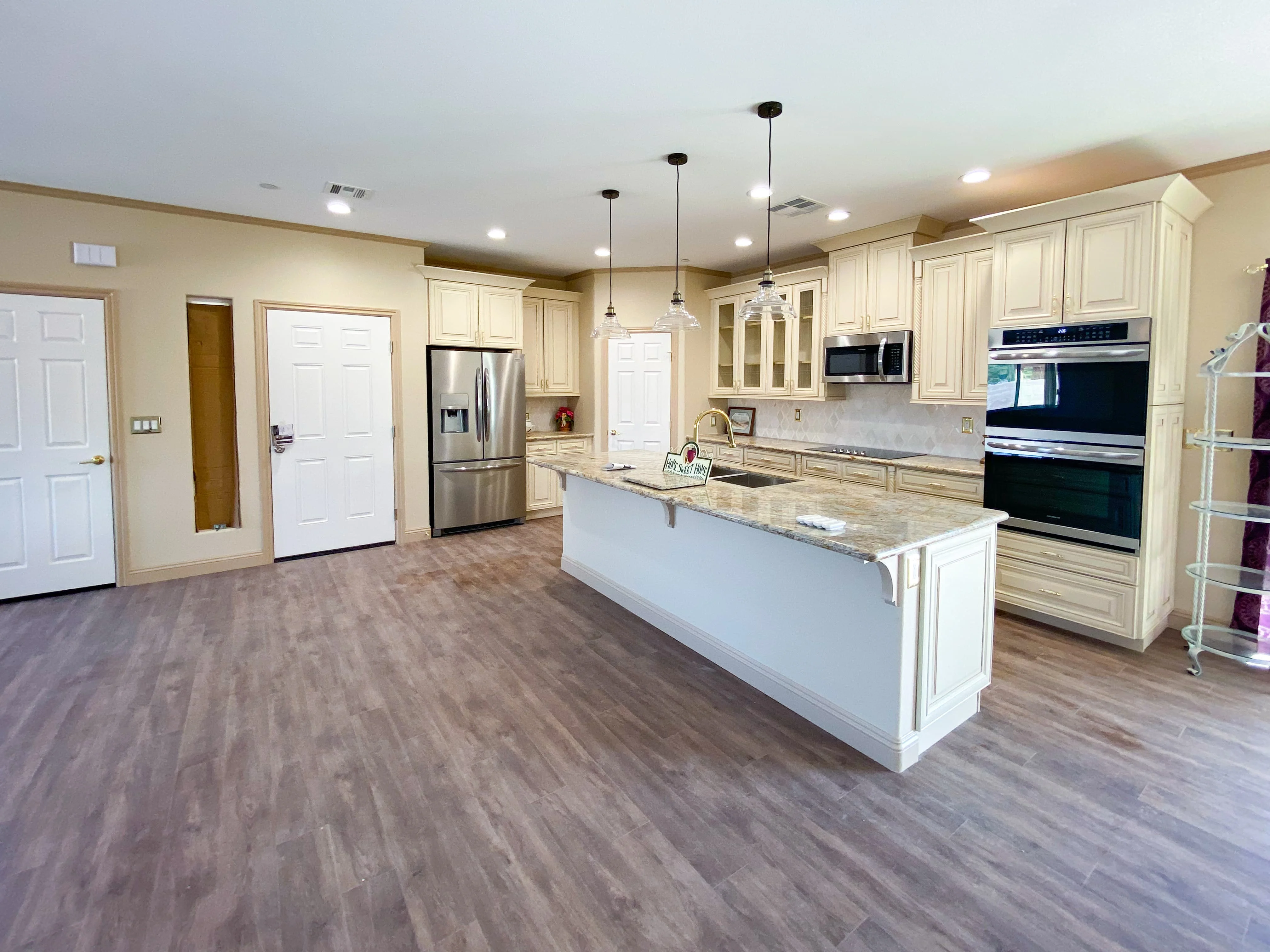 Open-concept living space combining dining and kitchen areas, flooded with natural light - Custom Home built by James Development Corp. Las Vegas, NV.