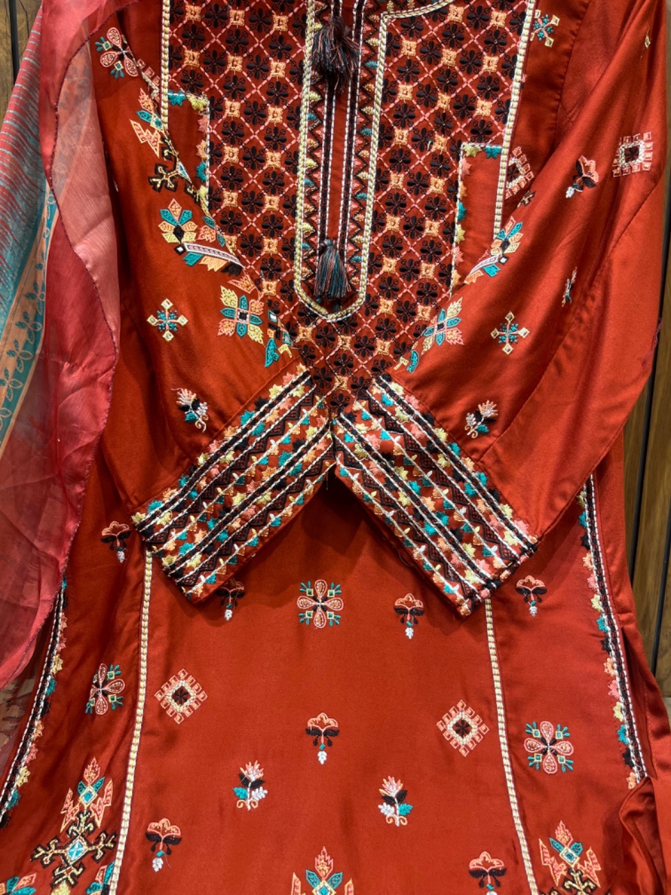 Elegant rust colour embroidery suit featuring intricate multicolor thread work on the neckline, daman, sleeves, and plazo border paired with a beautifully printed dupatta for a rich festive and party wear look.-1