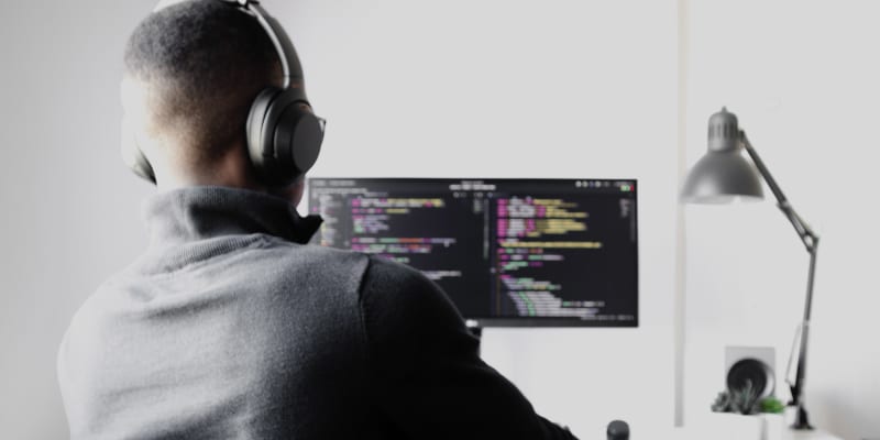 Programmer sitting in front of computer screen.