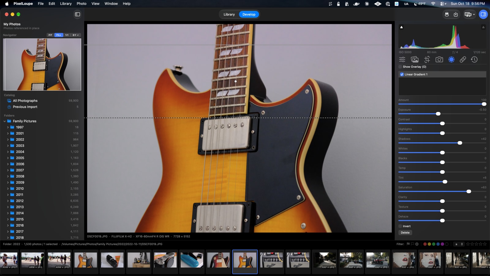 A linear gradient mask across a guitar body with its exposure, shadows and saturation sliders