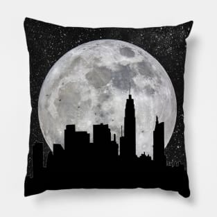 Silhouette of a city against a giant moon Pillow