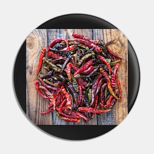 Dried chili peppers on a wooden board Pin