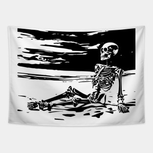 skeleton sits on the beach Tapestry