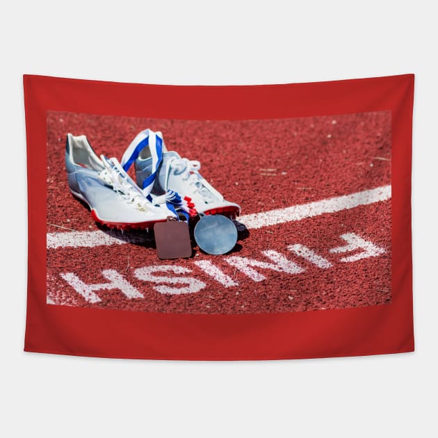 Racing spikes with medals at the finish line Tapestry by Woodys Designs