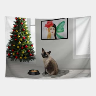 Siamese cat sitting in the white room with food and Christmas tree Tapestry