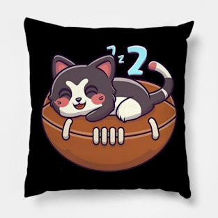 Cat napping on a American football Pillow