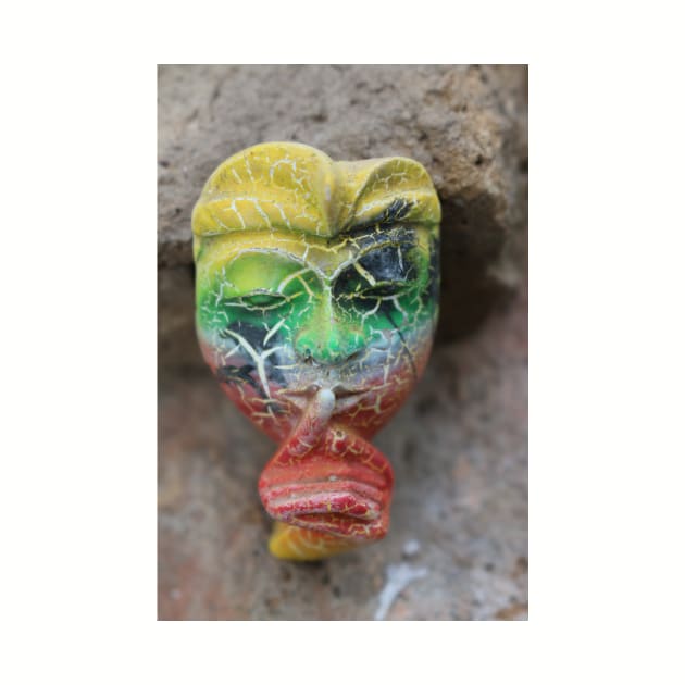 A Bali face mask with finger on its mouth. by kall3bu