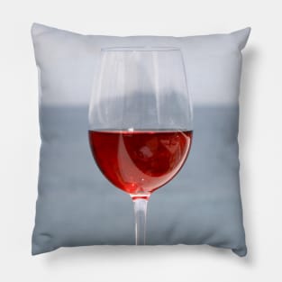 Glass of wine with sea in background Pillow