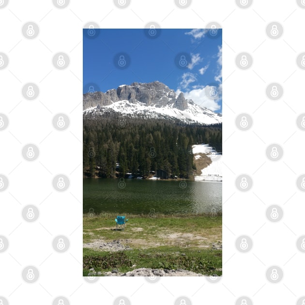 The fabulous alpine lake of Misurina in the Dolomites. Lovely and relaxing place in the Italian Alps. Chair on the shore. Reflections in the rippled water. Sunny spring day. by fabbroni-art