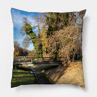 Wooden bridge over a pond surrounded by trees Pillow