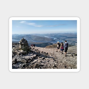Hikers pass a navigation cairn as they descend back down Ben Nevis Magnet