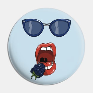 Mouth about to eat a blueberry while wearing matching blue sun glasses. Pin