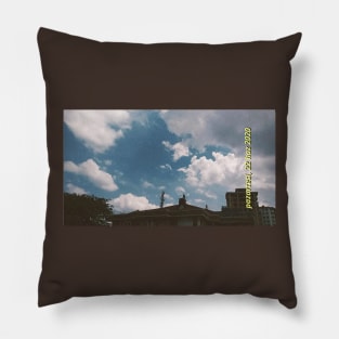 Blue cloudy sky and buildings Pillow