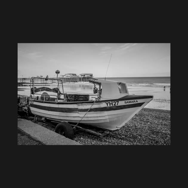 Traditional fishing boat on Cromer beach with the Victorian pier in the background by yackers1