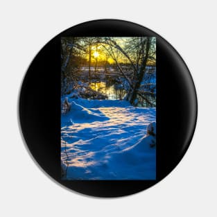 Snow falling on a river with snowy banks Pin