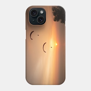 Paragliding over the ocean and treetops while golden sunset Phone Case