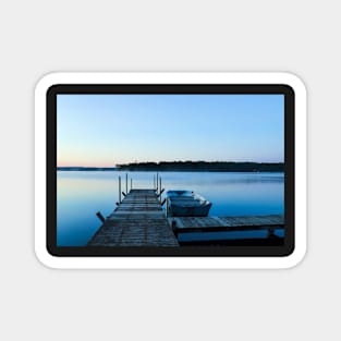 Wooden dock and a boat on blue clear water Magnet