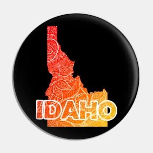 Colorful mandala art map of Idaho with text in red and orange Pin