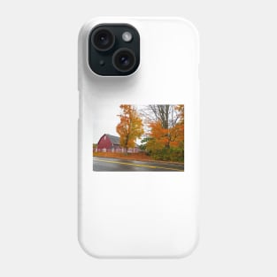 Traditional American style red barn from passing highway in fall with bright foliage in rural USA Phone Case