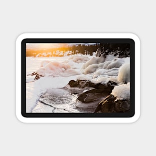 Warmth of orange sunlight on ice covered rocks Magnet