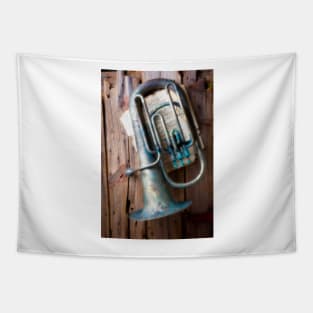 Weathered Tuba Hanging On Old Wall Tapestry