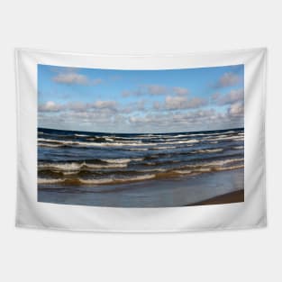 White cumulus clouds in sky over wavy Baltic sea Tapestry