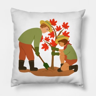 Young couple planting red maple tree. Outdoors gardening concept. Pillow