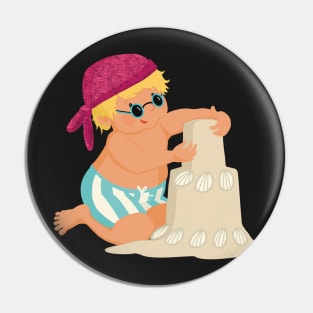 Cute little boy is on vacation building a sand castle on the beach, no background Pin