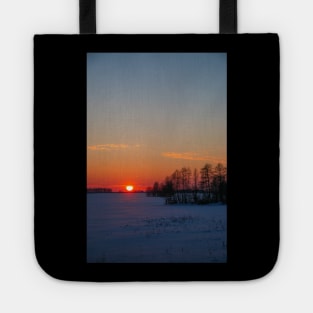 Sunset winter landscape with snow-covered road in violet and pink colors Tote