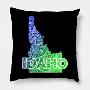 Colorful mandala art map of Idaho with text in blue and green Pillow